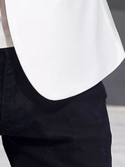 White double-breasted blazer with black trim detail over black pants