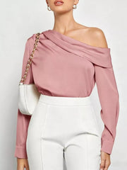 Elegant pink satin one-shoulder shirt with draped neckline and long sleeves.