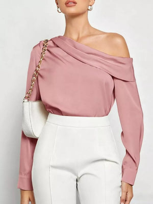 Elegant pink satin one-shoulder shirt with draped neckline and long sleeves.