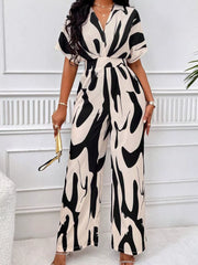 Black and white abstract print wide-leg romper with V-neck and short sleeves.