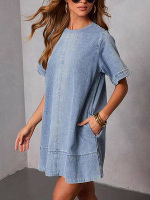 Light-wash denim A-line dress with crew neck, short sleeves, and pockets.