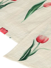 Tulip print midi dress in cream with red floral pattern and green leaves.