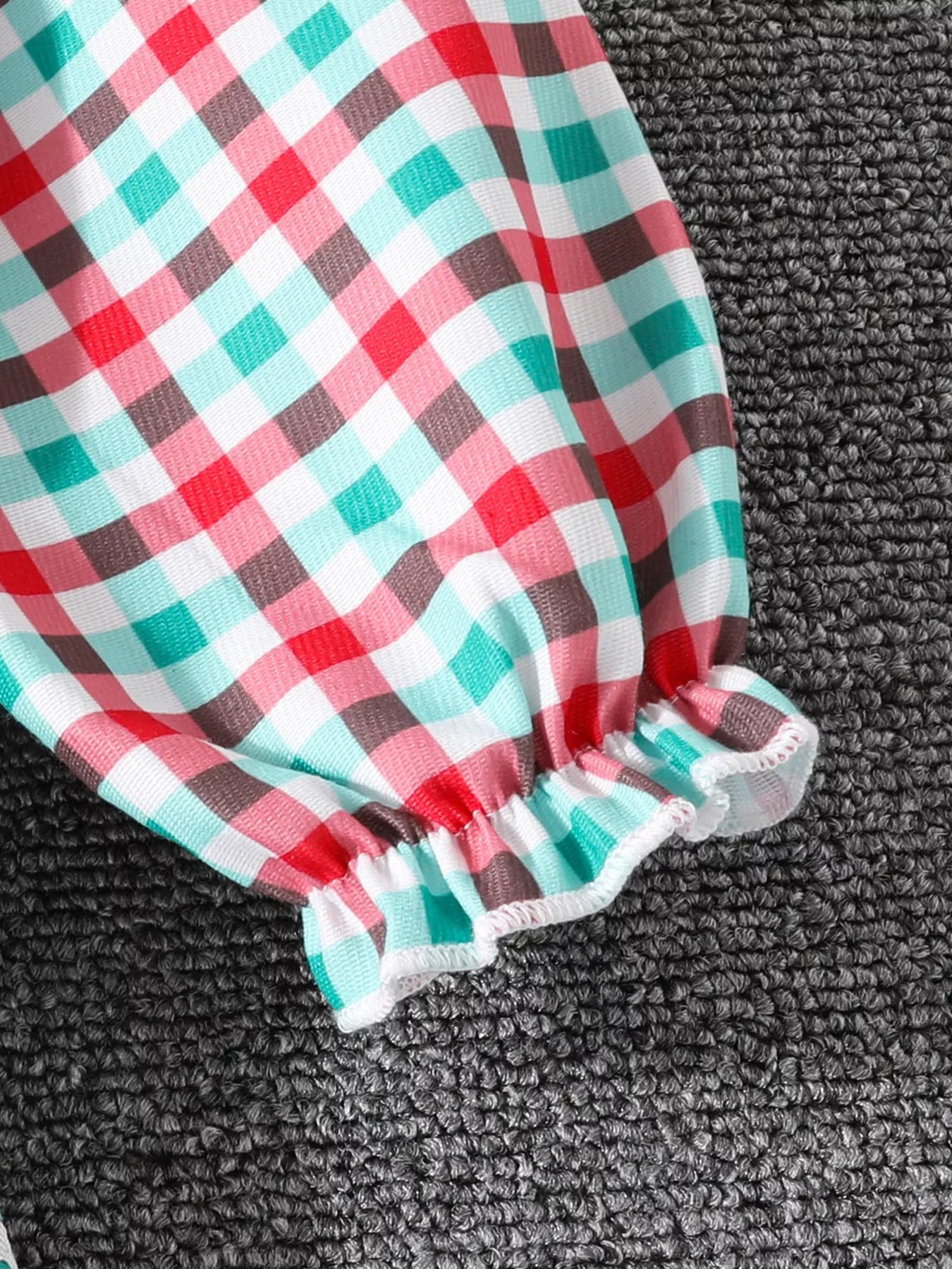 Festive plaid dress sleeve with ruffled cuff in multicolor.