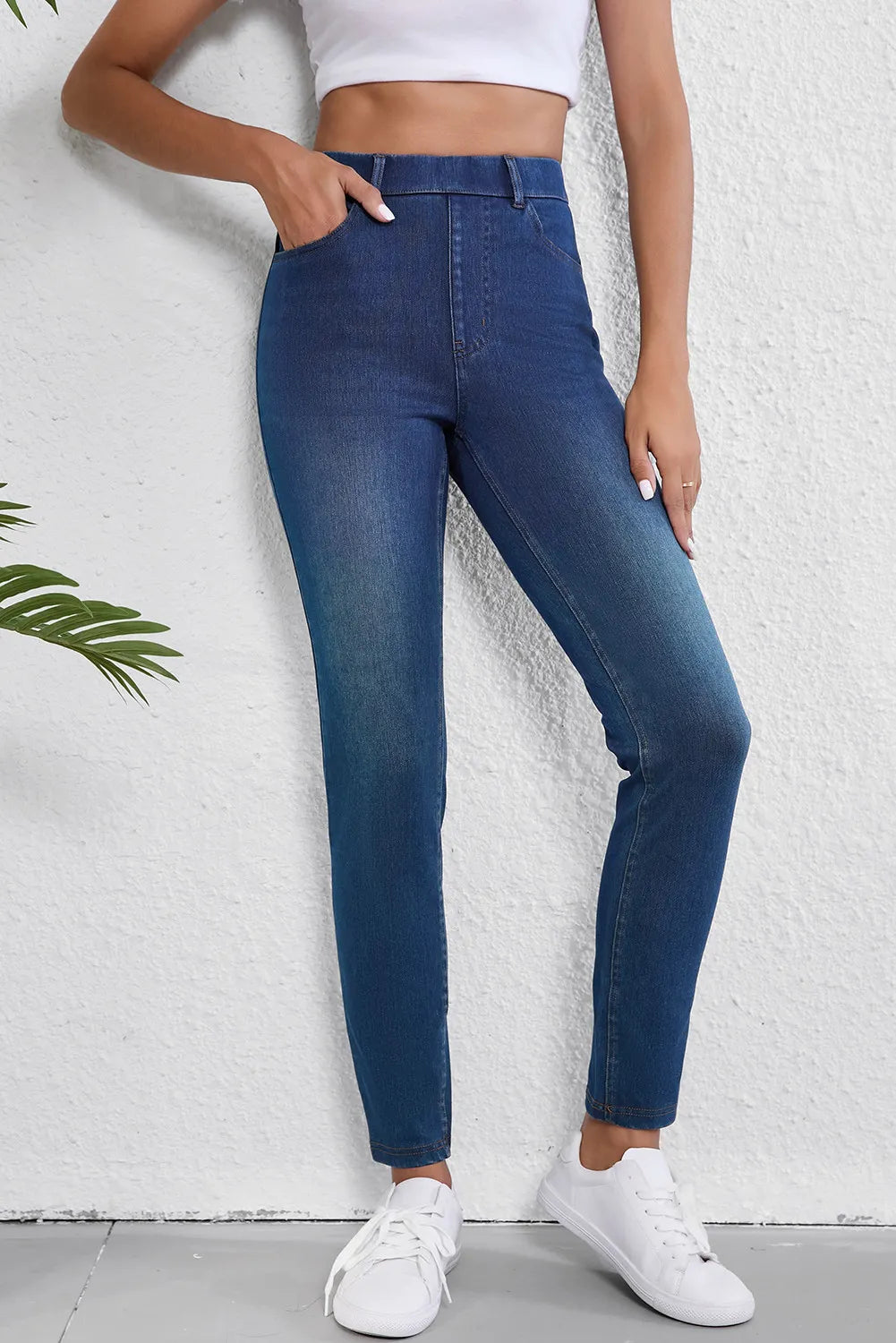 Medium wash denim pull-on jeans with a high waist and slim fit.