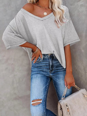 Grey waffle knit relaxed v-neck t-shirt with contrast stitching and dropped shoulders.