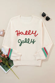 Ivory knit sweater with red "Holly" and green "Jolly" embroidery, striped cuffs.