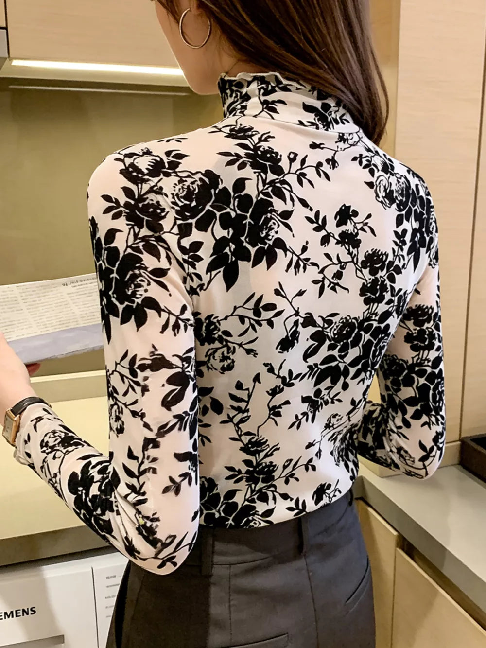 Sheer floral maternity t-shirt with ruffles and mock neck.
