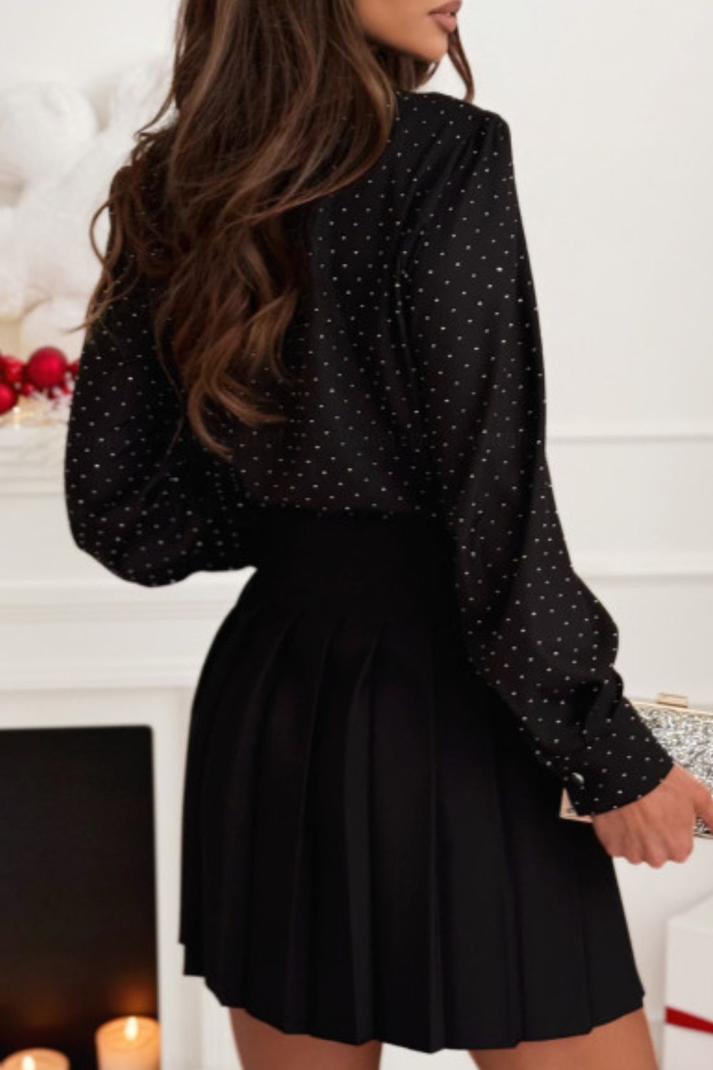 Black polka dot blouse with button cuffs and a keyhole neckline detail.