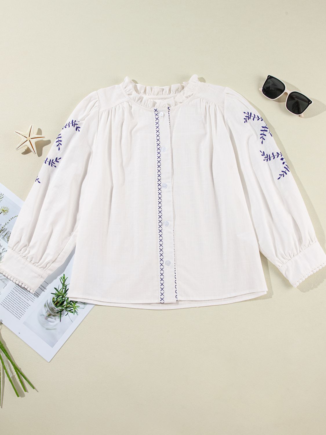 White embroidered blouse with ruffled neckline and scalloped trim cuffs