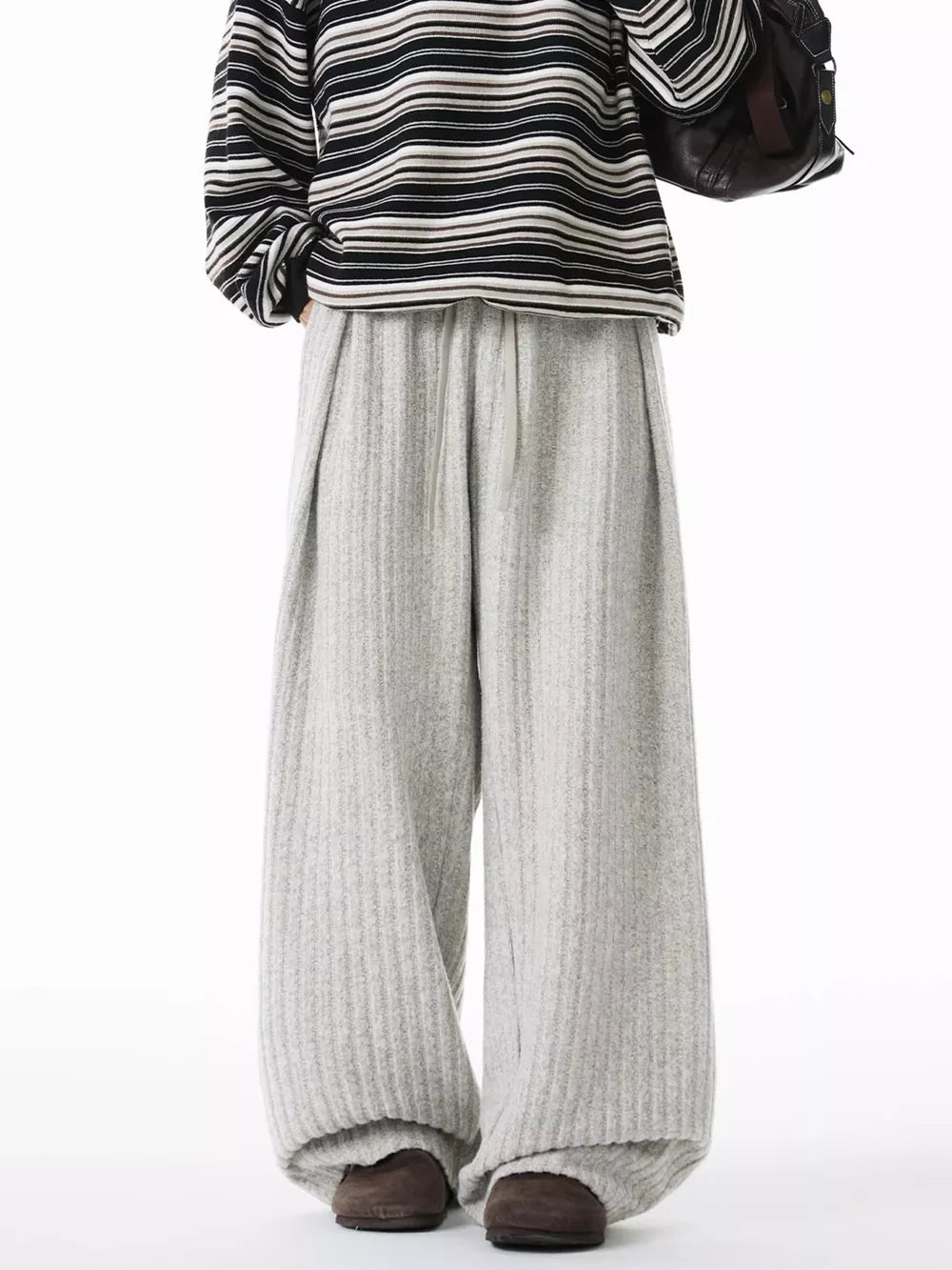 Relaxed ribbed knit sweatpants in light gray with a drawstring waist and wide leg.