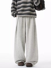 Relaxed ribbed knit sweatpants in light gray with a drawstring waist and wide leg.