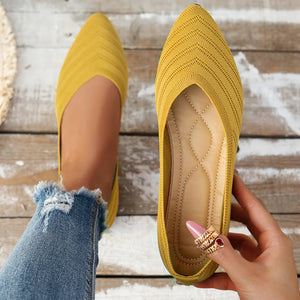 Yellow knitted pointed-toe ballet flats with chevron pattern and cushioned insole.