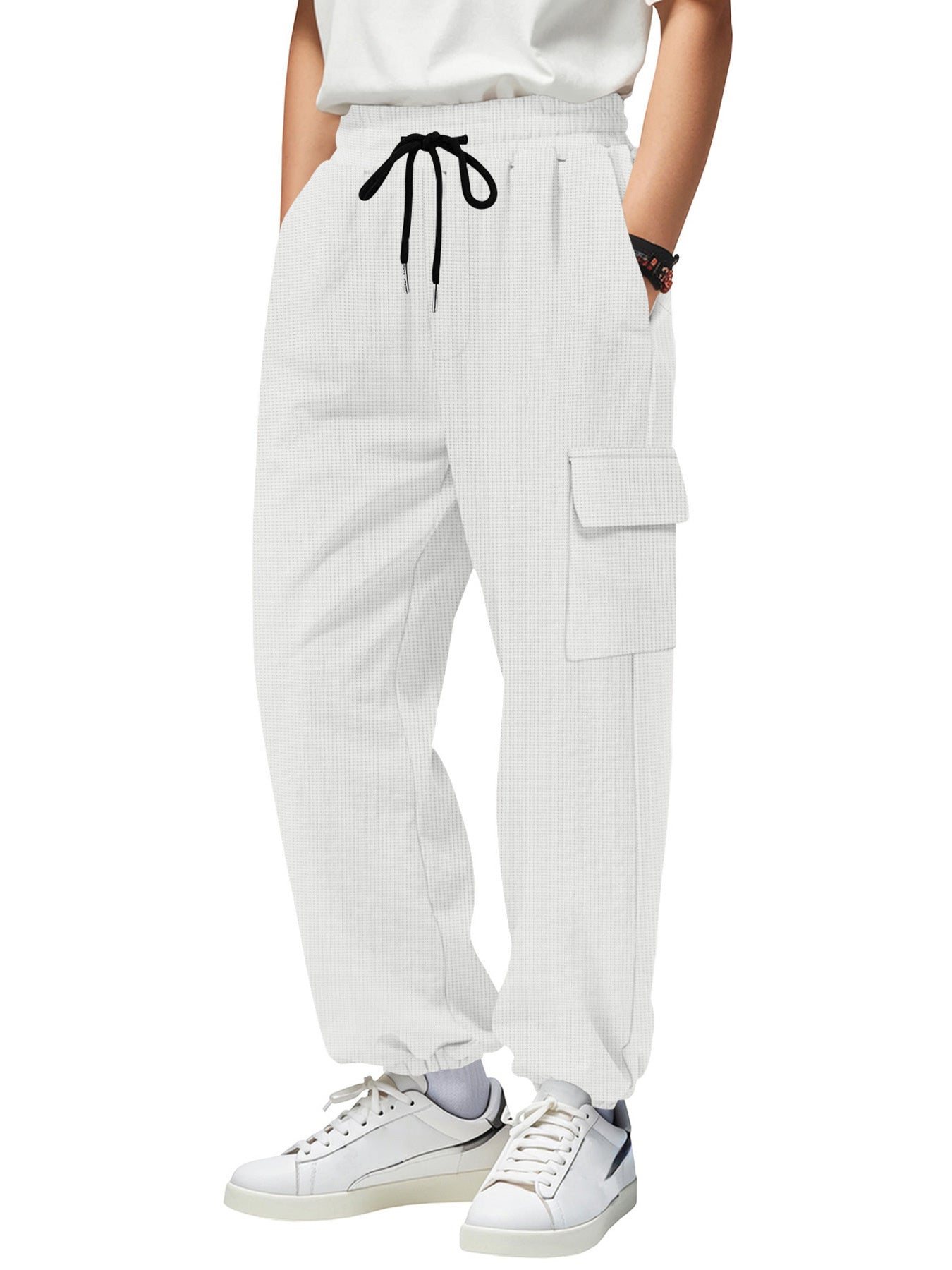 White waffle knit joggers with drawstring and cargo pockets.