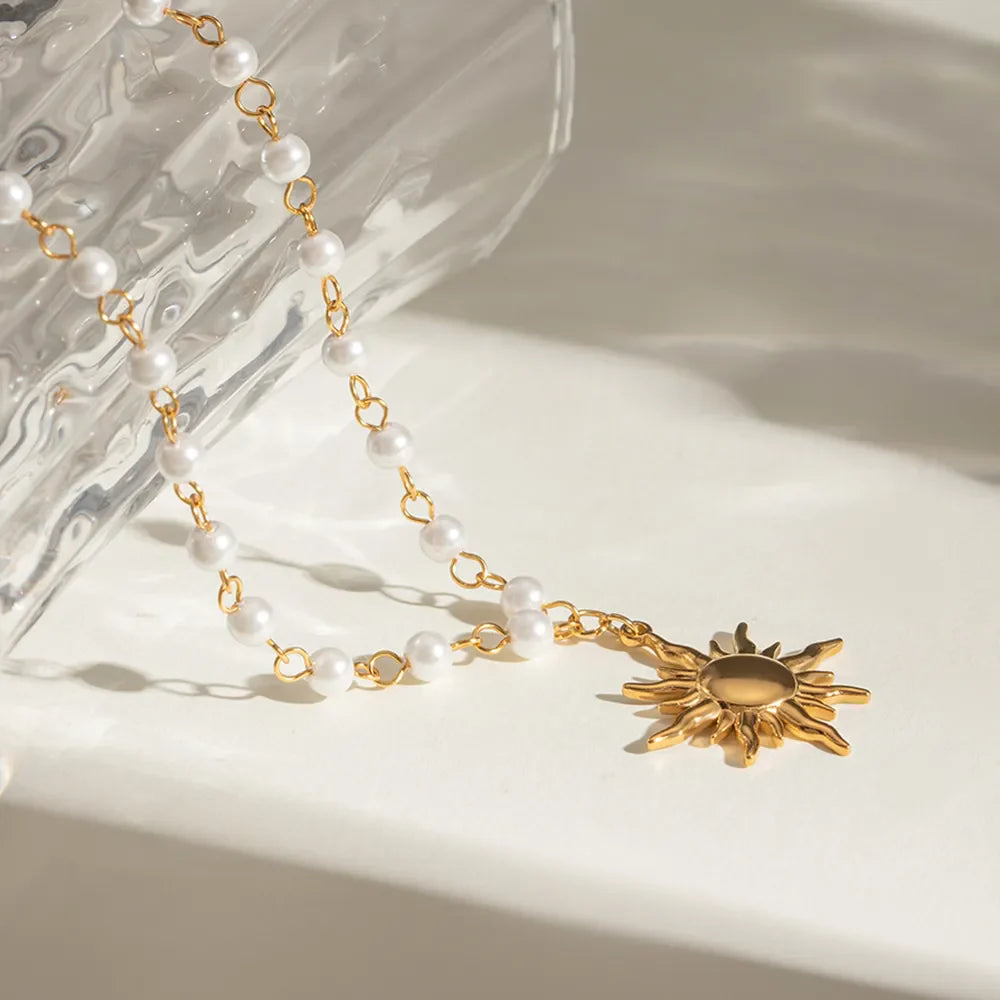Gold celestial pearl drop pendant necklace with sun charm