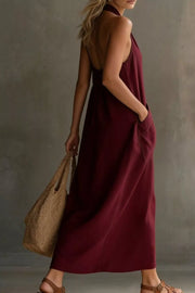Burgundy halter midi dress with pockets and a backless design.