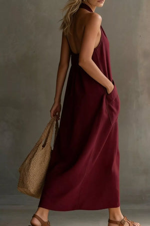 Burgundy halter midi dress with pockets and a backless design.