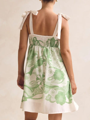 Green floral tie-strap mini dress with smocked bodice and pockets