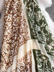 Dual-pattern V-neck cami dress with brown and green floral prints and cream panels.