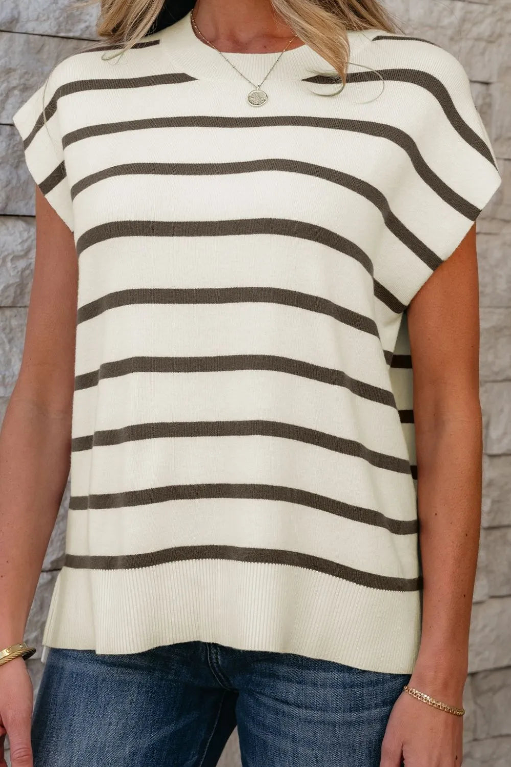 Striped knit cap-sleeve top with slit hem, crew neck, and relaxed fit.