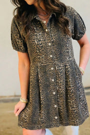 Leopard print denim dress with puff sleeves, collared neckline, and button front.