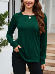 Green textured knit top with raglan sleeves and crew neck, styled casually.