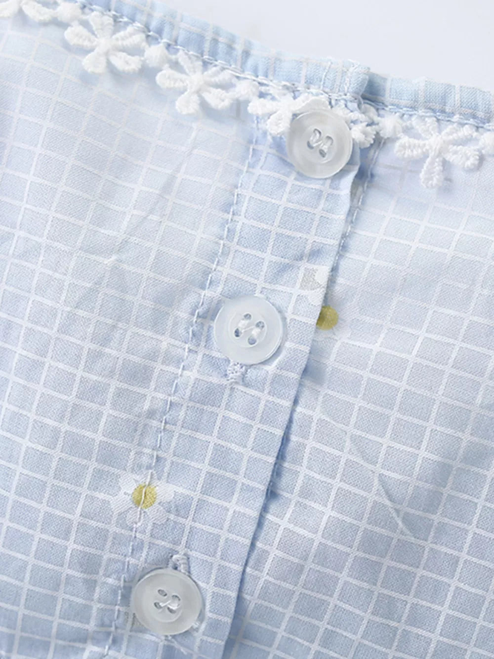 Baby dress with blue gingham, white lace trim, and daisy embroidery.