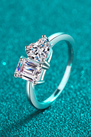 Silver dual-cut moissanite engagement ring with heart and emerald cut stones.