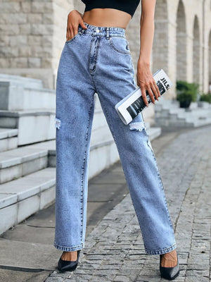 Ripped high-waisted light wash denim jeans with a button closure and straight leg cut.