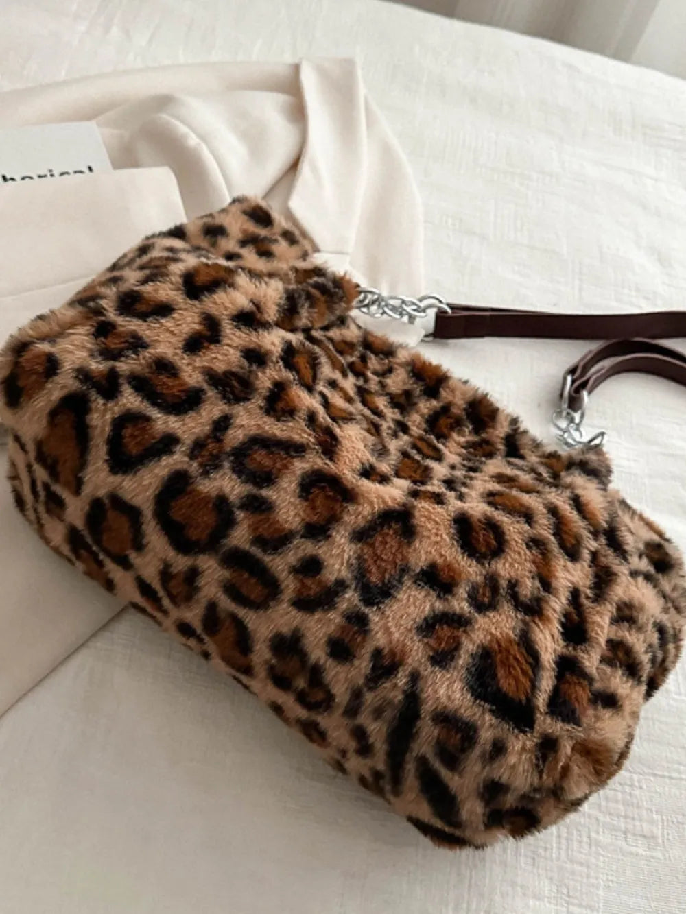 Leopard print faux fur shopper bag with chain handle and brown leatherette strap.