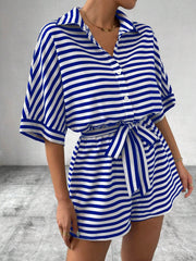 Royal blue and white striped button-front romper with short sleeves and self-tie belt.