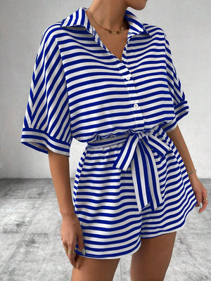 Royal blue and white striped button-front romper with short sleeves and self-tie belt.