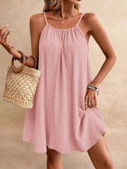 Dusty Pink spaghetti strap mini dress with gathered neckline and textured fabric.