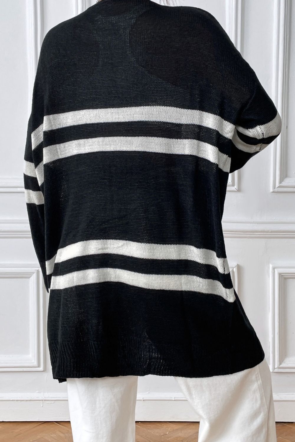 Black and white striped oversized knit cardigan with a relaxed fit.