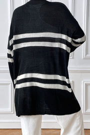 Black and white striped oversized knit cardigan with a relaxed fit.