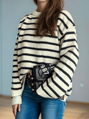 Breton stripe relaxed knit sweater in white with black stripes, crew neck, and long sleeves.
