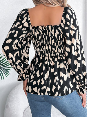 Black leopard print square neck blouse with smocked bodice and ruffled cuffs.