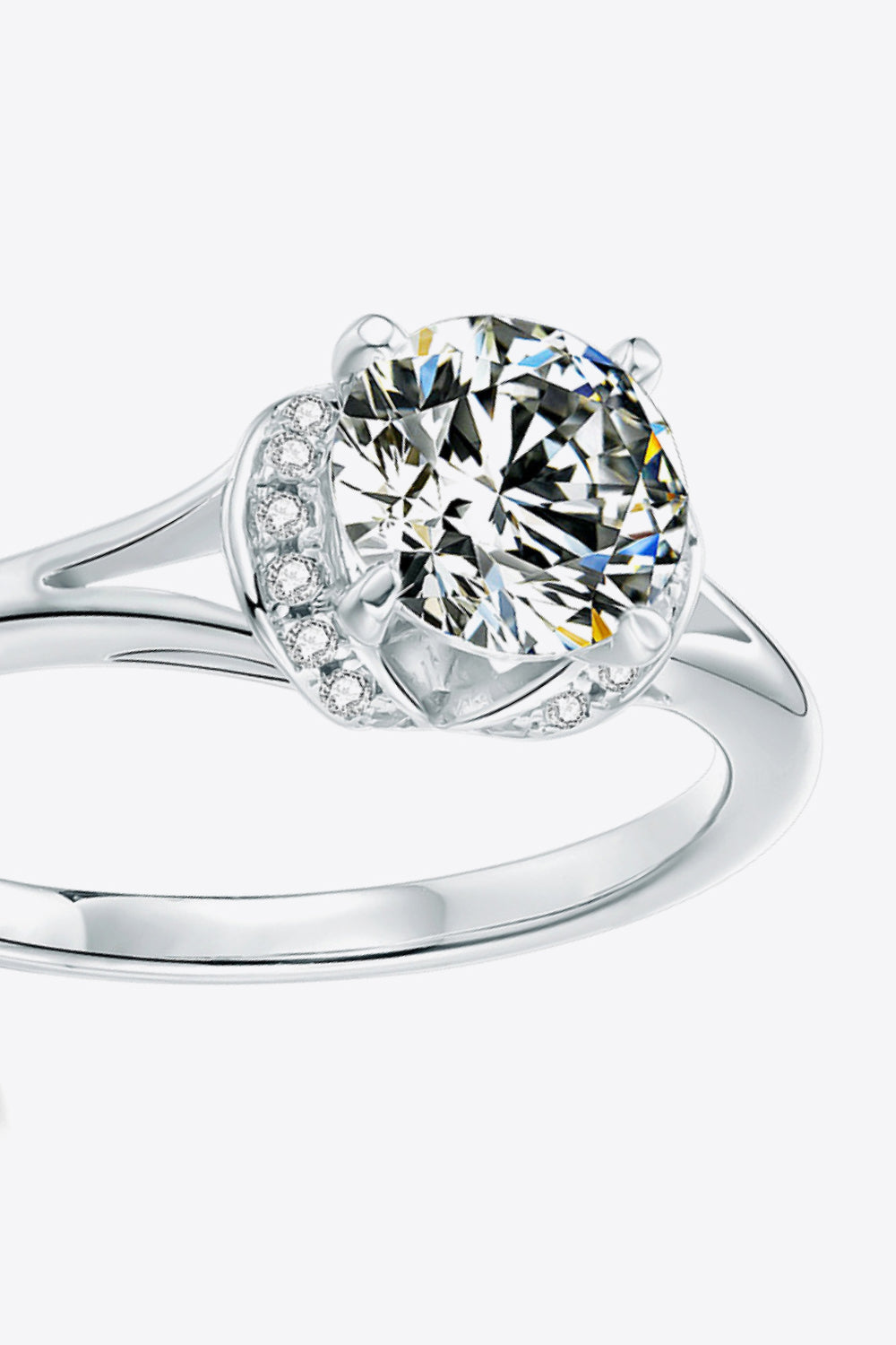 Silver split shank halo moissanite ring with round center stone and pavé accents.