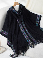 Black knit hooded wrap with embroidered trim and fringe detail