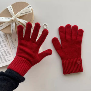 Luxurious wool knit gloves in deep red with ribbed cuffs and button detail.