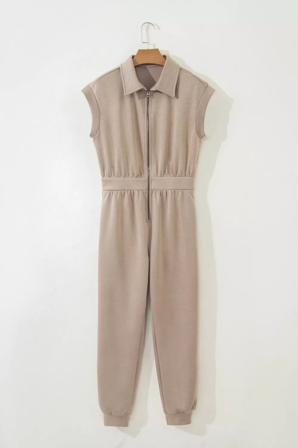 Collared zip front romper in tan with cap sleeves and ankle cuffs