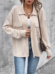 Beige textured overshirt with relaxed fit, button front, and chest pockets.