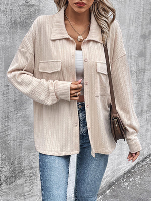Beige textured overshirt with relaxed fit, button front, and chest pockets.