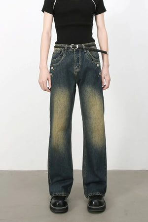Dark wash bootcut jeans with button details and faded accents.