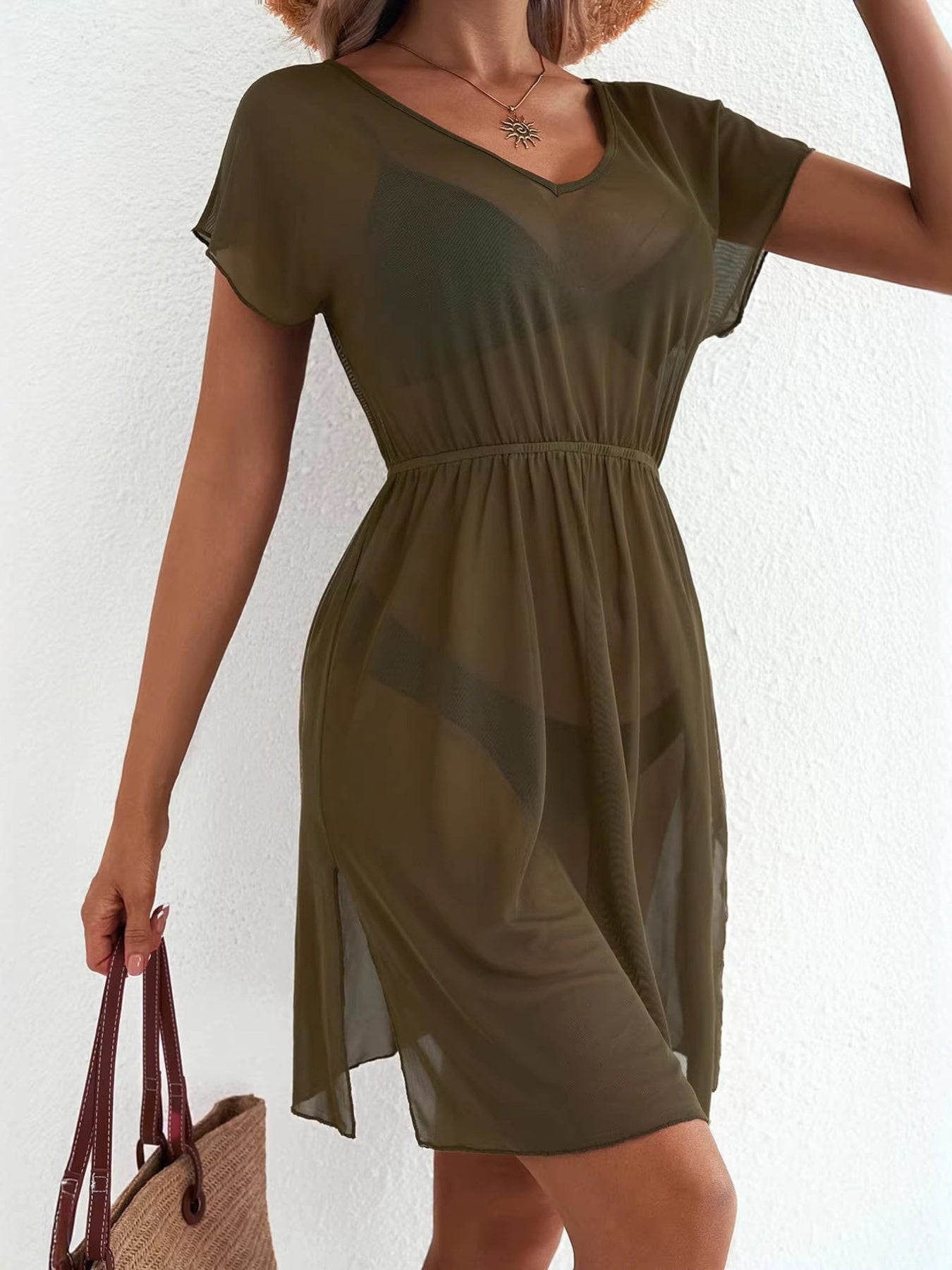 Green sheer mini dress with V-neck, short sleeves, elastic waist, and side slit.