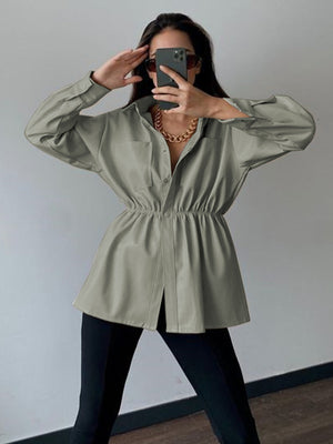Matcha green faux leather shirt jacket with gathered waist and button front.
