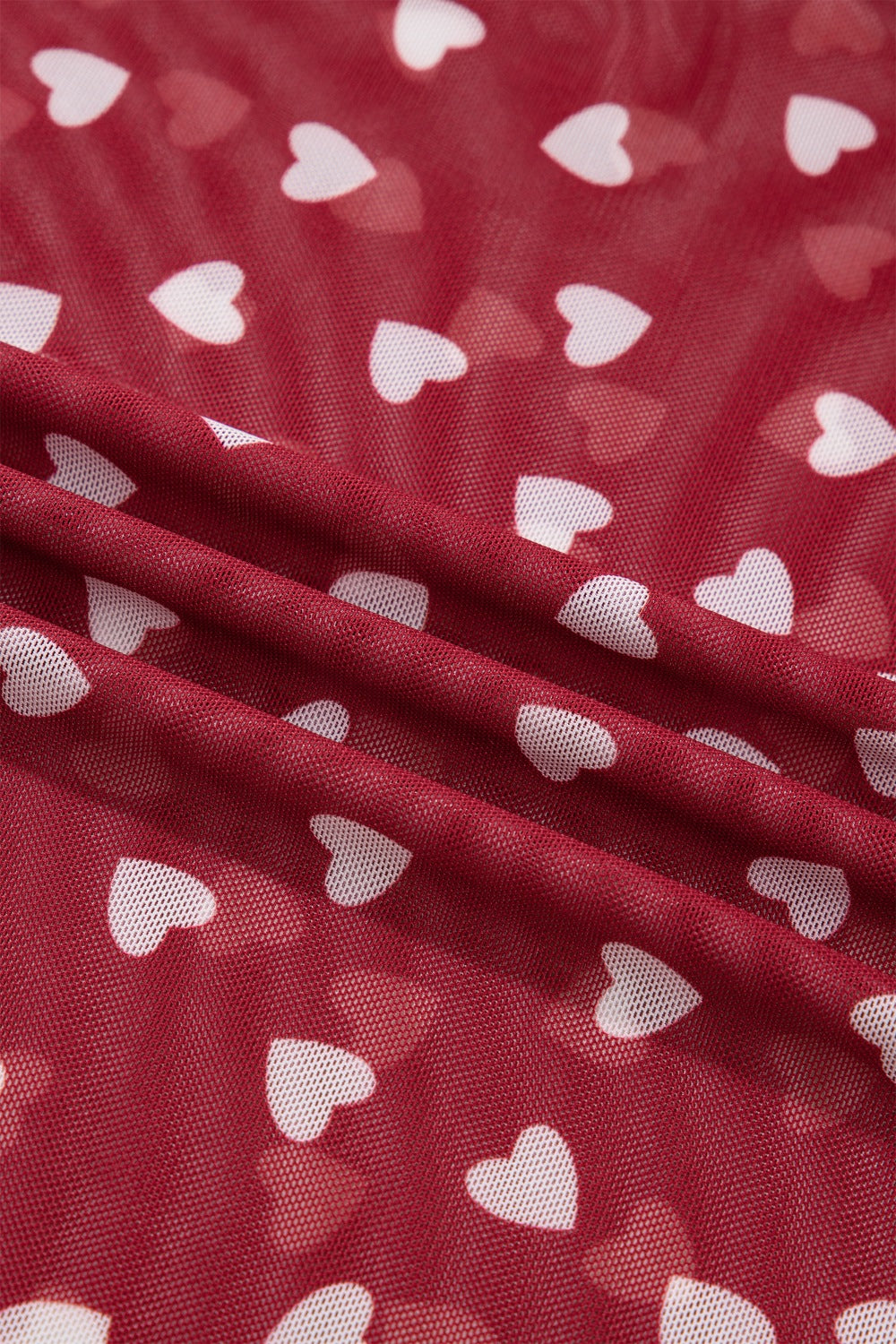 Deep red sheer t-shirt with white heart print, mesh fabric detail.