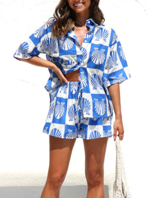 Blue and white checkered resort set with shell print, featuring a button-up shirt and drawstring shorts.