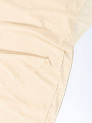 Backless ruffled mini dress in beige with asymmetrical hem detail