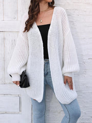 White open knit cardigan with balloon sleeves and a relaxed fit.