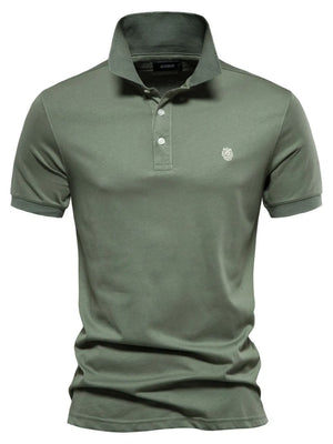 Moss green tailored cotton polo shirt with embroidered crest detail.